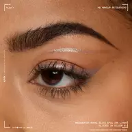 A close-up macro shot of a person's eye, with a silver eyeliner expertly applied along the waterline and inner corner, showcasing the product's finish on skin in shade 01 Glitzed In Silver