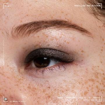 Close-up of an eye wearing NYX Professional Makeup Party Animals Lid Lingerie Cream Eye Pigment in Gothic Garter, a deep metallic black shade.