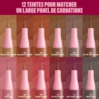 Display of 12 nude shades of NYX Lip Lingerie Liner. Each shade is shown in a vertical pen format with pink caps and labeled with names like "Take You There," "Warm Up," "Baby Doll," and "Cuff Me." Title reads: "In 12 sexy lip-enhancing nudes!"